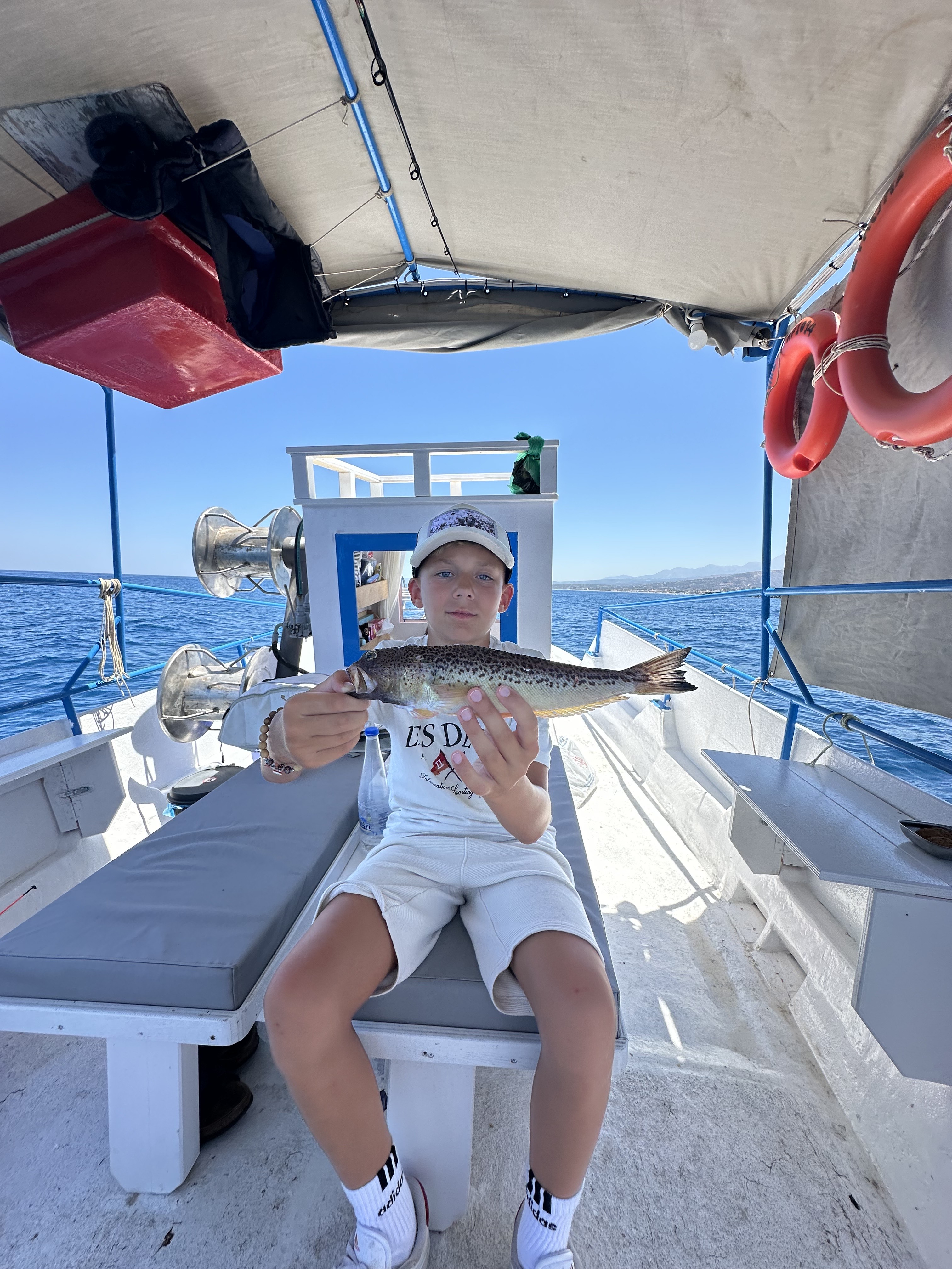 A young fisherman that caught a fish